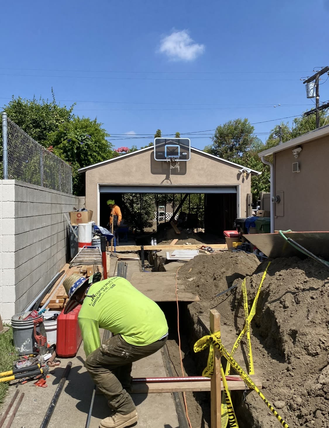 Utility trench dug from the main house to a new backyard ADU