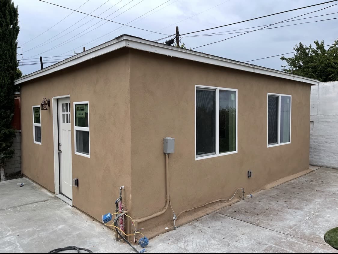 Side elevation of a finished stucco ADU with private entrance